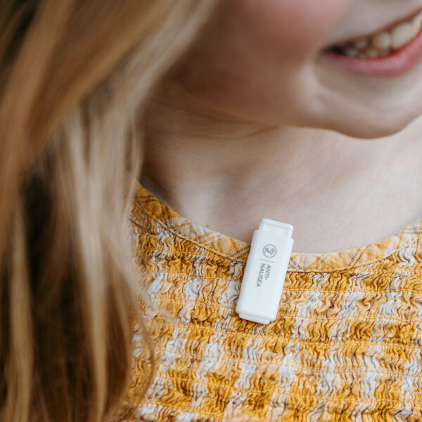 Child wearing Anti-Nausea waterless essential oil diffuser on shirt