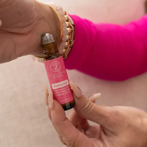 Woman applying Scentral Zone's Romance Roll-on Blend to wrist.
